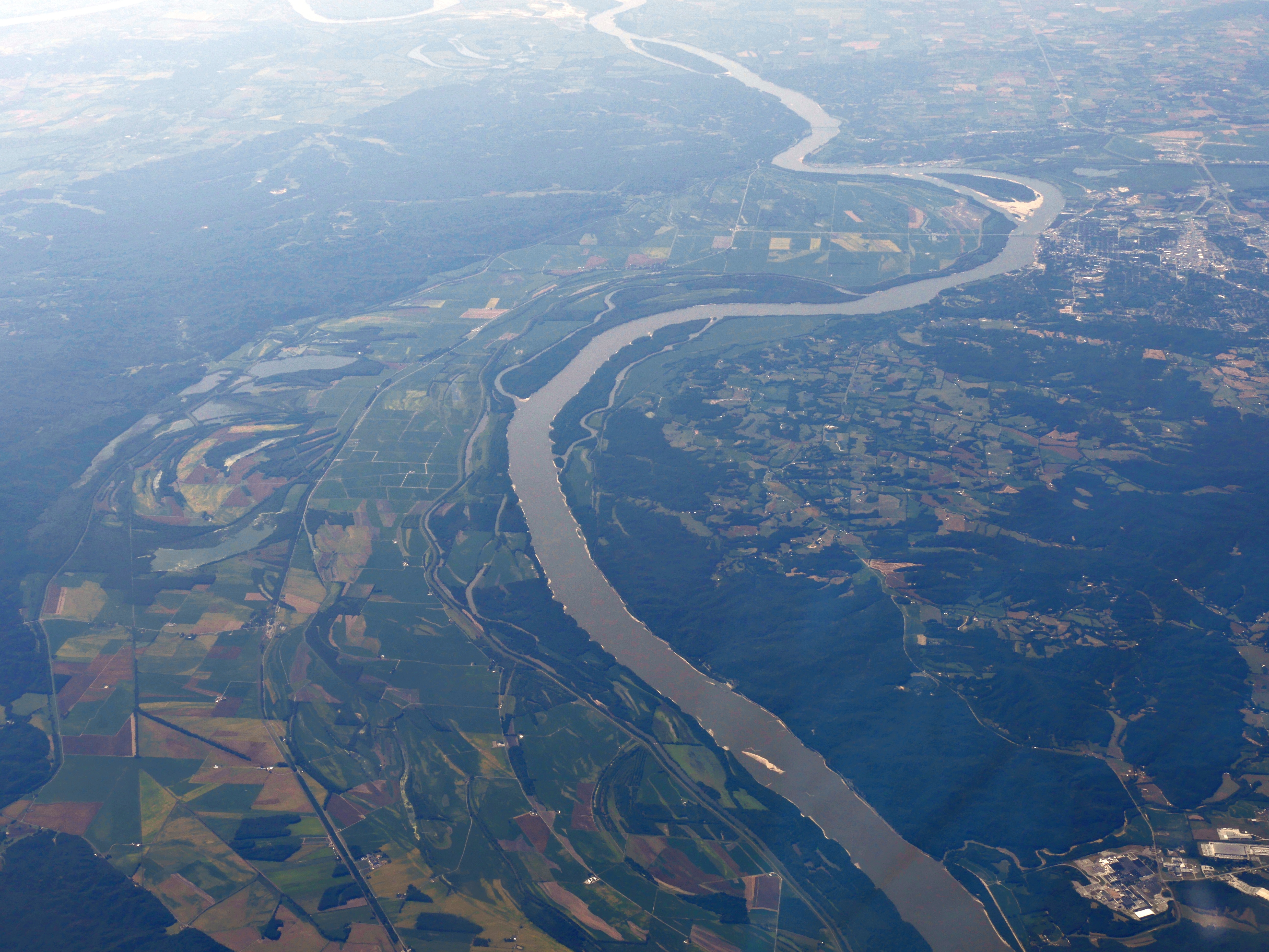 Aerial view of Mississippi River snaking around farmlands in Louisiana