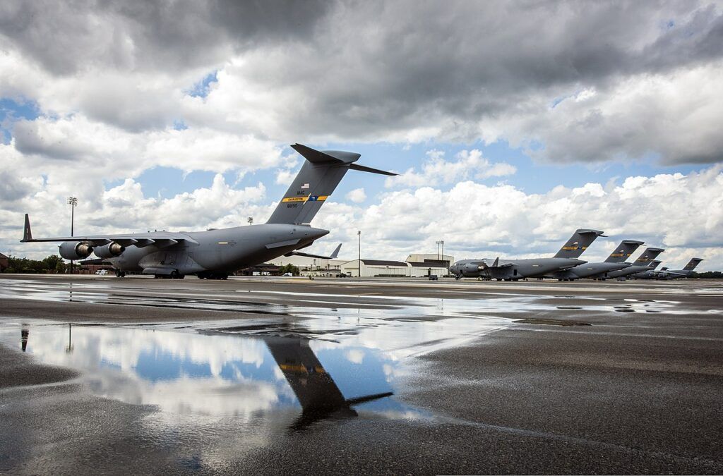 C-17 Globemaster III's assigned to the 437th Airlift Wing sit on the flight line after a rain storm passes over May 7, 2013, at Joint Base Charleston -Air Base, S.C. The C-17 is capable of rapid strategic delivery of troops and all types of cargo to main operating bases or directly to forward bases in the deployment area. The aircraft can perform tactical airlift and airdrop missions and can transport litters and ambulatory patients during aeromedical evacuations when required. 