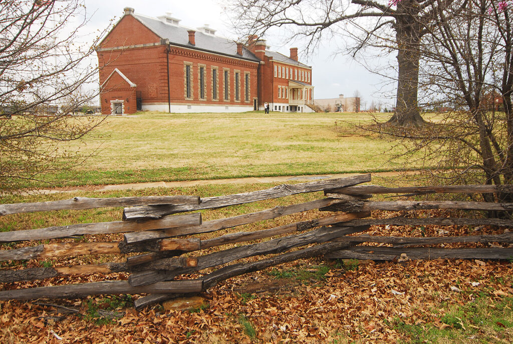 Fence and brick building on the grounds of Fort Smith Historic Site