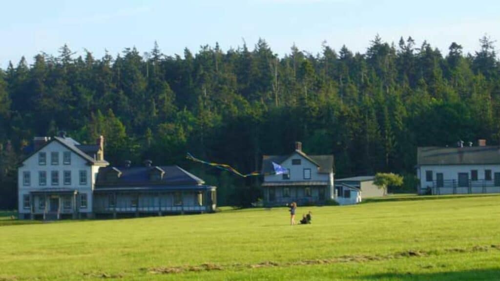 Kite flying on the parade ground at Fort Flagler State Park in Washington. The old hospital building (left) and the ranger's residence is seen in the background.